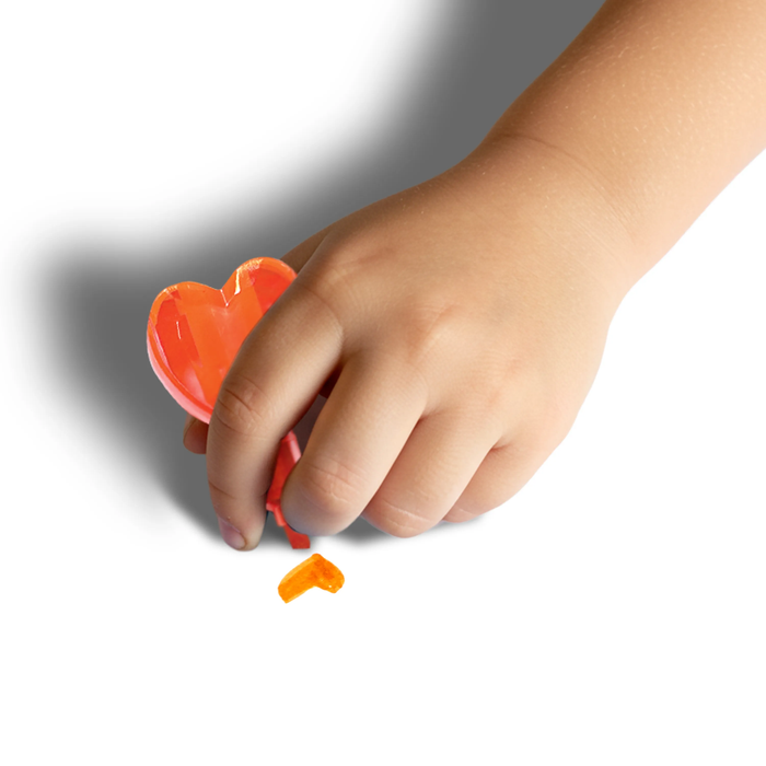 Kid holding orange OOLY Heart Stacks Stacking Highlighter with a drawn orange heart