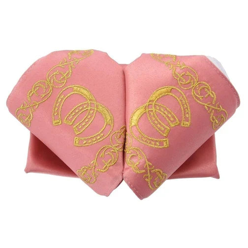 A traditional Mexican charro hat with a pink satin base and yellow embroidered details.