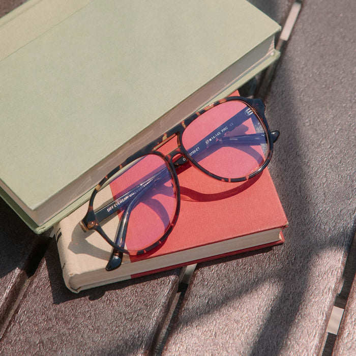 still life - diff eyewear featuring the tatum aviator glasses with a espresso tortoise frame some books