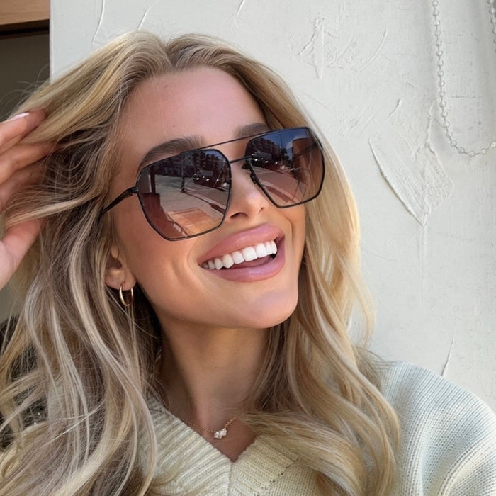 UGC - shelbyhunstad wearing diff eyewear Berkely navigator sunglasses with a black metal frame and twilight gradient lenses