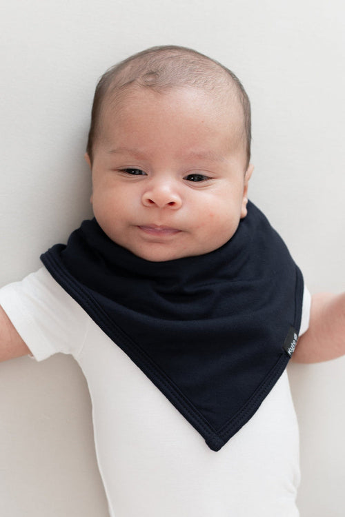 Baby wearing the Kyte Baby Bib in Midnight