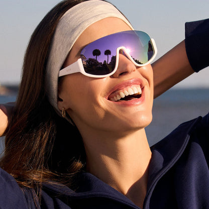 on model - female wearing diff sport featuring the blazer shield sunglasses with a matte white frame and lavender mirror polarized lenses angled view