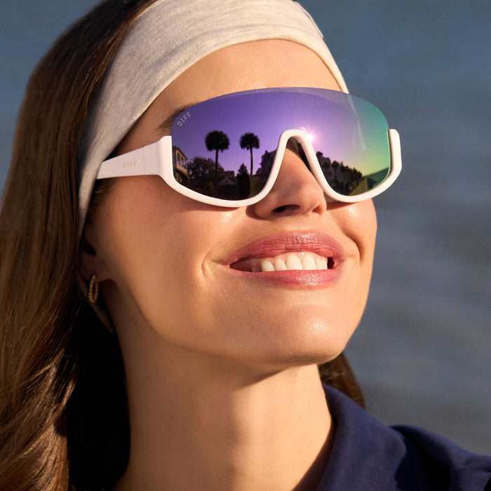 on model - female wearing diff sport featuring the blazer shield sunglasses with a matte white frame and lavender mirror polarized lenses front view