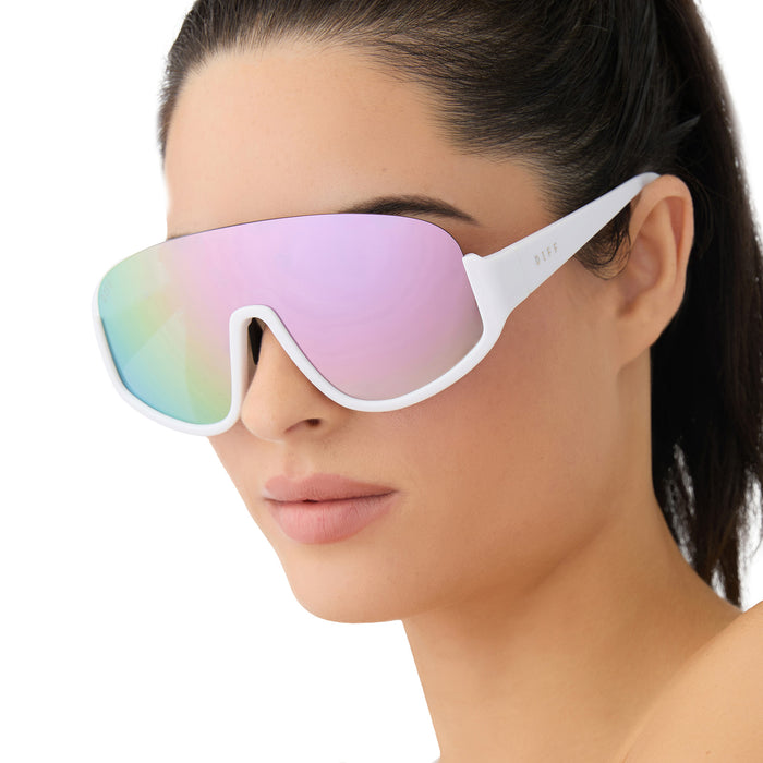 on model - female wearing diff sport featuring the blazer shield sunglasses with a matte white frame and lavender mirror polarized lenses angled view