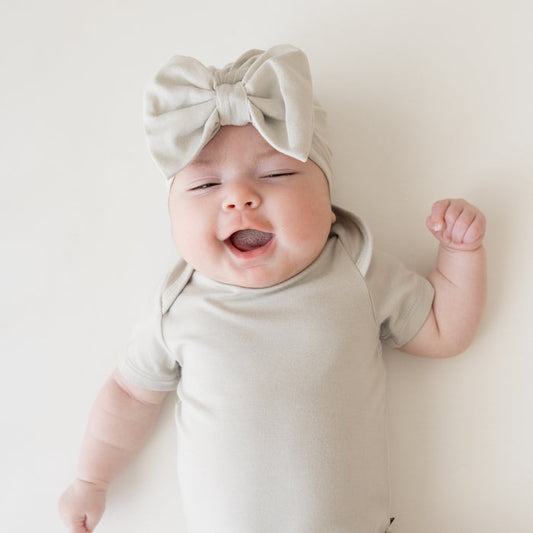 Baby wearing Bow Headwrap and bodysuit in Oat