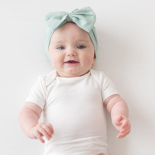 Baby wearing sage headwrap bow
