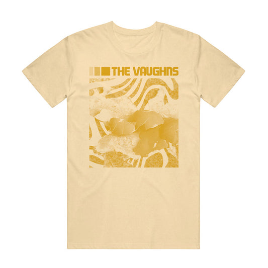 The Vaughns Broken Egg T-Shirt in beige features an abstract yellow design with wavy lines, shapes, and layered textures. "THE VAUGHNS" is printed in bold at the top on soft Comfort Colors fabric.