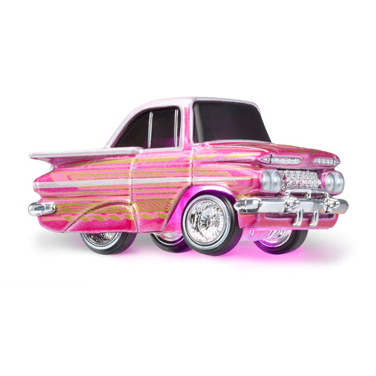 Pink vintage car model with pink light underneath on a white background