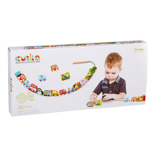 The Cubika Wooden Lacing Toy Flying Cars features a young boy playing with colorful vehicle blocks. The white packaging displays the Cubika logo and states it’s suitable for ages 36 months and up, perfect for fine motor skill development.