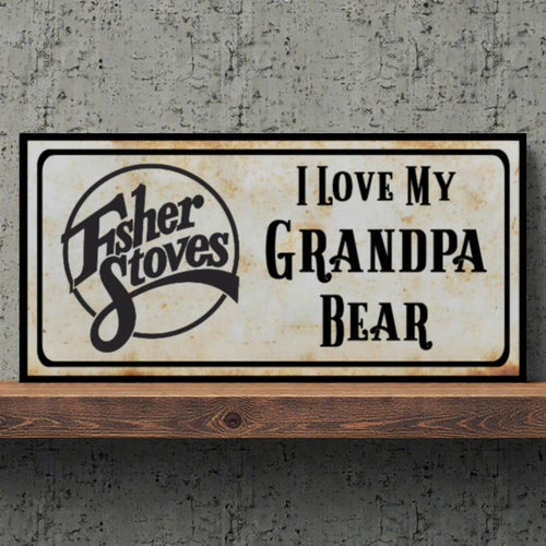 Framed sign with 'I Love My Grandpa Bear' text and Fisher Stoves logo on a concrete wall.