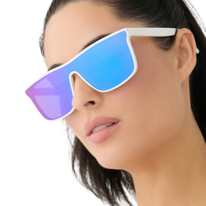 on model - female wearing diff sport featuring the flash square sunglasses with a matte white frame and purple mirror polarized lenses angled view