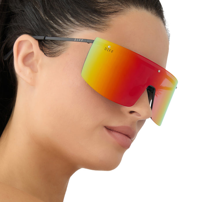 on model - female wearing diff sport featuring the grandslam shield sunglasses with a black frame and rainbow mirror polarized lenses side view