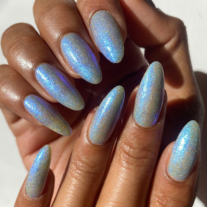 Close-up, top angled shot of nails done with Mausoleum Nail Lacquer on medium skin tone.