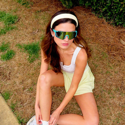 lifestyle - female - shannonvwilkie wearing diff sport featuring the heat shield sunglasses with a turquoise frame and turquoise ice mirror polarized lenses