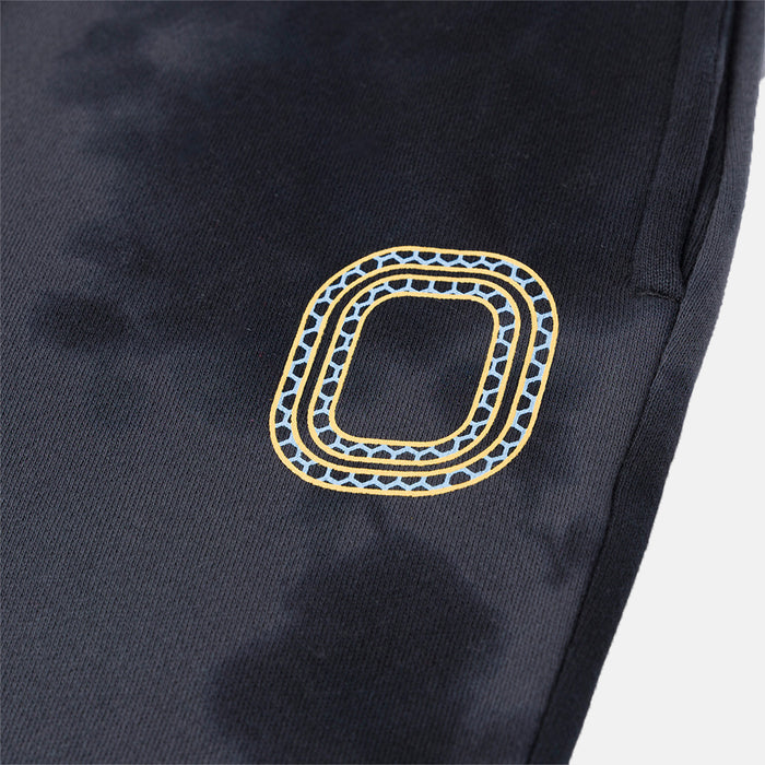 Up close view of emblem on the Overtime Kids' Aura Dye Jogger.