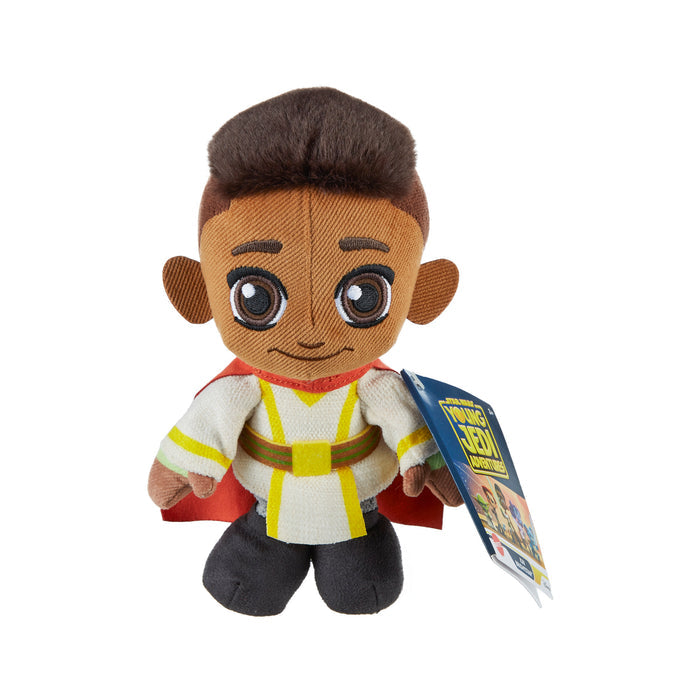 The Mattel Star Wars Young Jedi 8in Plush features a smiling cartoon boy with brown skin and big eyes in a white and yellow outfit with a red cape—perfect for fans of the Disney+ series.