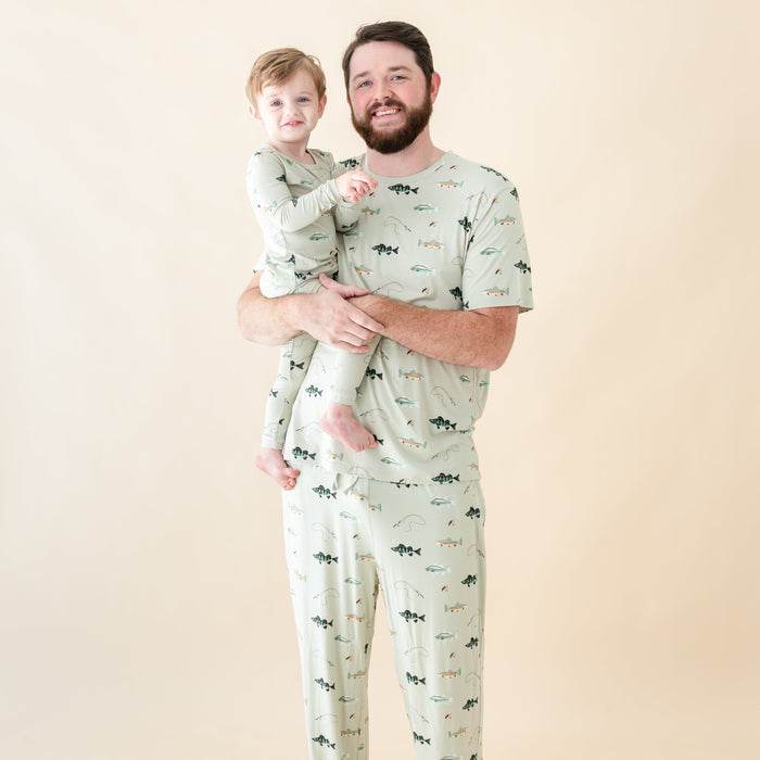 Father and son wearing matching family pajamas in fishing print