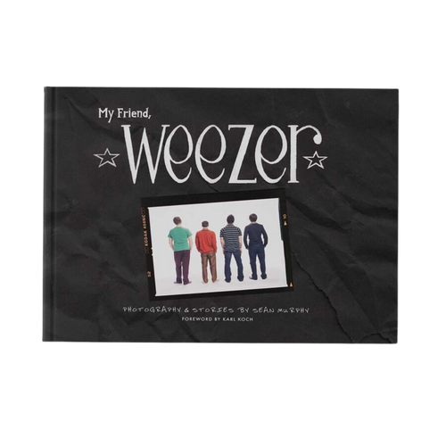 Black hardcover book my friend weezer with white stylized text and photo of rock bands in music photography from weezer official store
