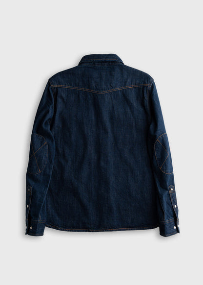 Dark denim shirt with elbow patches, back view. Features buttoned cuffs and contrast stitching on a plain white background.