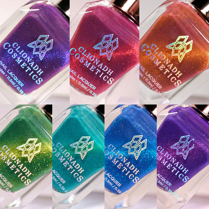 Close-up collage of seven bottles of nail polish from the Saturated Slick Nail Lacquer Collection.