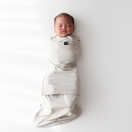 Baby sleeping swaddled in Sleep Bag Swaddler in Oat 0.5