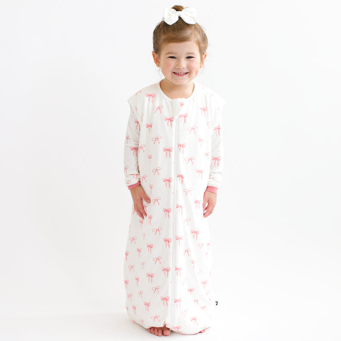 Toddler smiling modeling Sleep Bag Walker in Bow 1.0