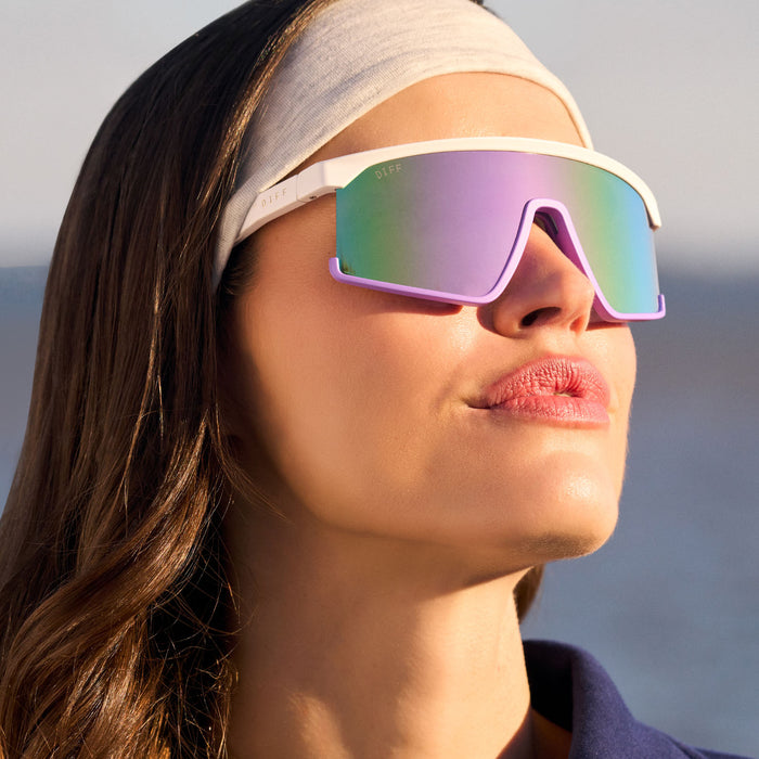 on model - female wearing diff sport featuring the spike shield sunglasses with a matte white + lavender frame and sherbert rainbow mirror polarized lenses front view