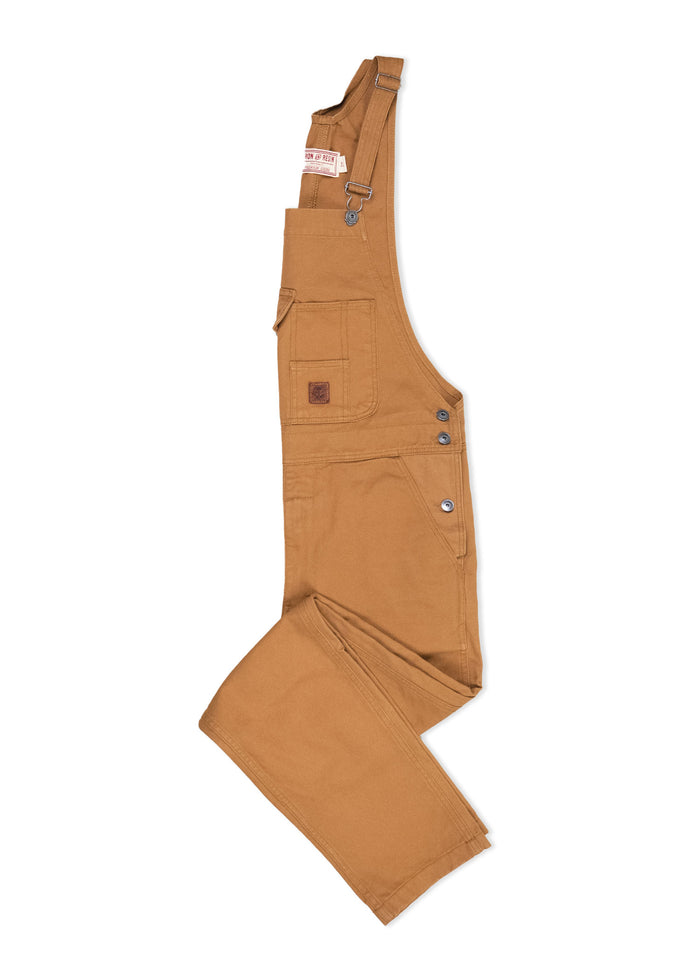 Brown canvas overalls with adjustable straps, side buttons, and front pocket, laid flat on a white background.