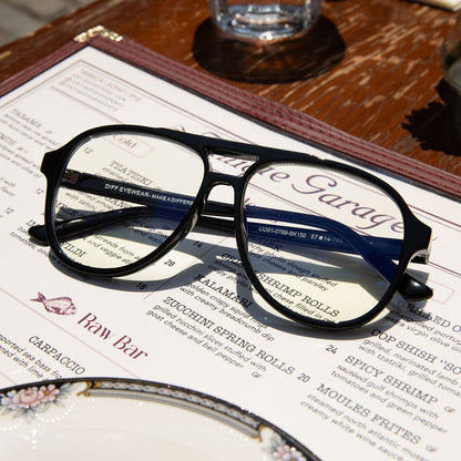 still life of tatum black prescription glasses laying on a menu