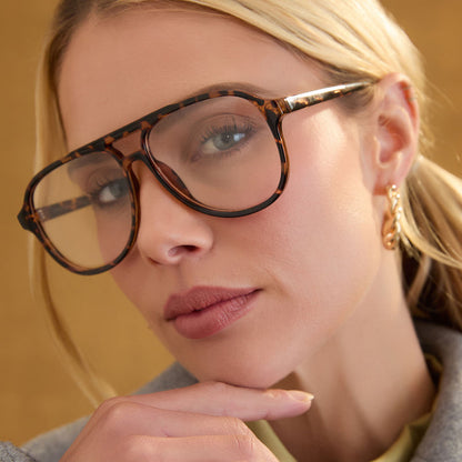lifestyle - female wearing diff eyewear featuring the tatum aviator prescription glasses with a espresso tortoise frame angled view