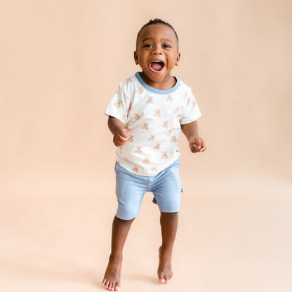 toddler boy jumping and smiling wearing  Toddler Basic Tee in Teddy Bear