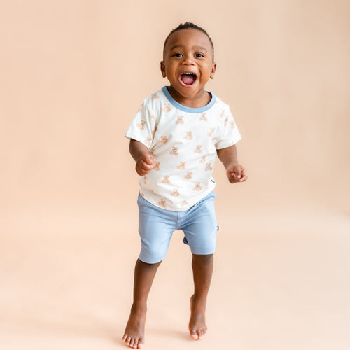 toddler boy jumping and smiling wearing  Toddler Basic Tee in Teddy Bear
