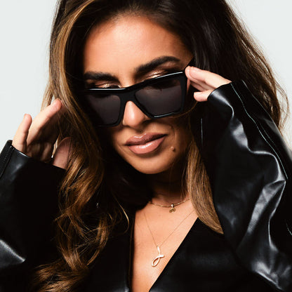 lifestyle - female wearing jessie james decker x diff eyewear featuring the vivi cateye sunglasses with a black frame and grey lenses front view