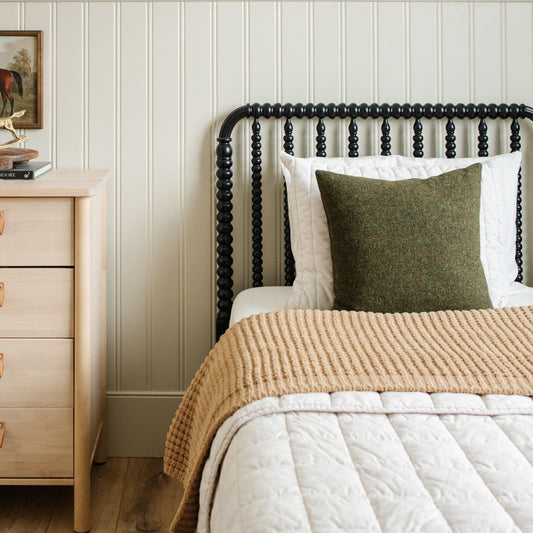 Tan twin waffle knit blanket cozily folded over, made into a cozy bed.
