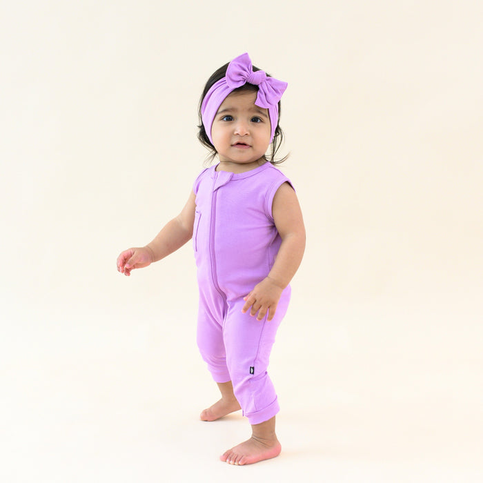 Toddler wearing Kyte Baby Sleeveless Zippered Romper with Dual Zipper in Poi